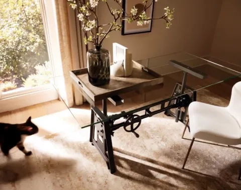 A study by a large window: a desk with a glass top on a cast-iron mechanical base with a handwheel, a white chair, a vas