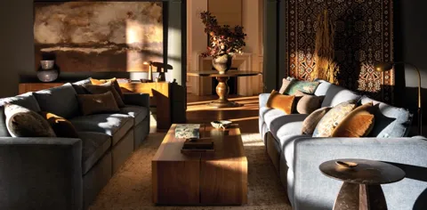 The sun moves to the side and a warm band falls across a sofa. The upholstery texture appears: a dense rib that read smo