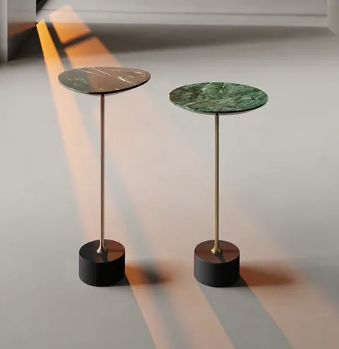 Light from the window runs across the floor in a warm band. The shadows of the tables stretch out — showing how slim the