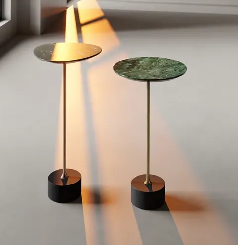 The beam reaches the first top and lights it from within: the dark stone turns honey and the veining emerges. The green 