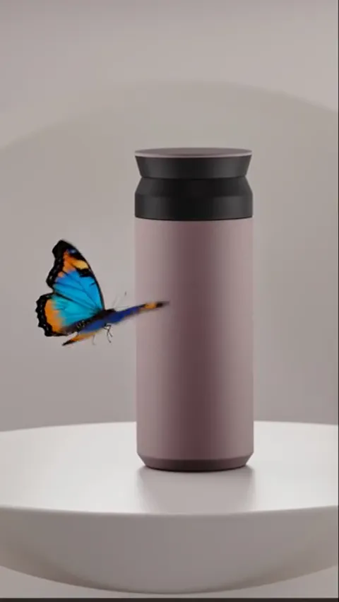 The butterfly beside the body, wings open. Blue and orange next to dusty pink show how muted the tone really is — on whi