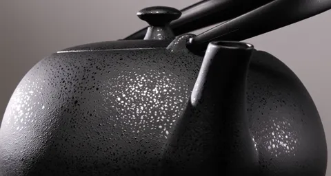The frame turns slightly, bringing in the spout and where it joins. The relief runs across the whole body and does not b