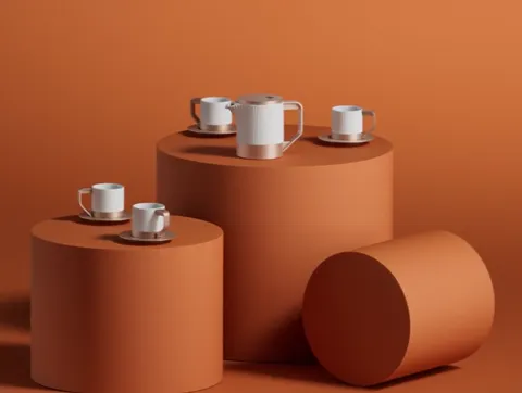 The set is arranged on terracotta cylinders of different heights against a ground of the same tone. The white pot and cu