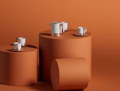 A lower angle, the pot nearly in profile. The straight spout, the flat lid with a loop handle, and the fact the cups are