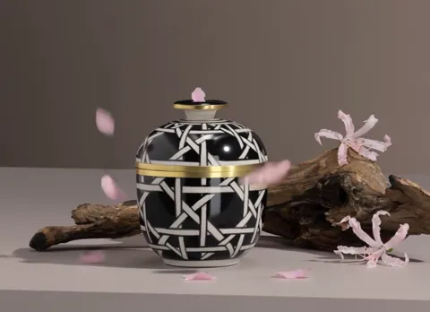 Petals fall from above. One lands on the lid — showing that the pattern runs across it too, not just the body.