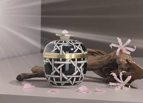 The finale: petals on the table, the jar at the centre. Five seconds have shown the ceramic under changing light — a pho
