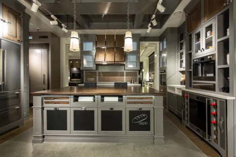 Deeper in, the far corner opens up with a tall unit and an extractor. The kitchen turns out to be U-shaped rather than a