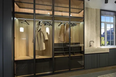 Closer to the doors: the metal frame and its divisions are legible, the glass smoked. The internal lighting works throug