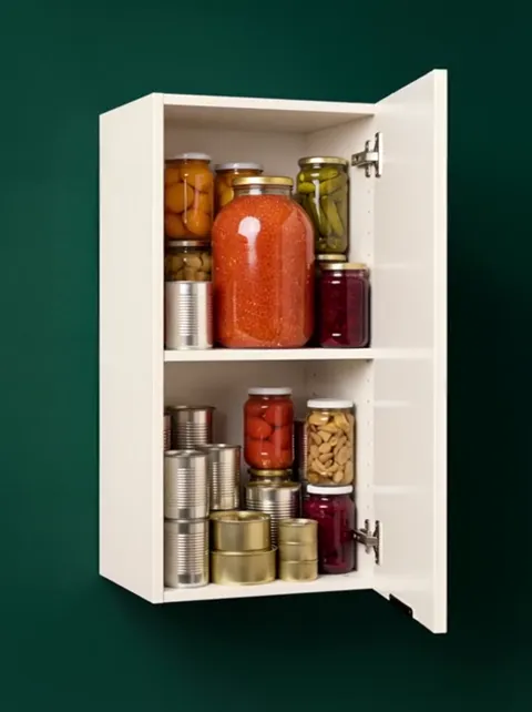 The door swings further, both shelves fully visible. The gap between them takes a three-litre jar — a dimension no descr