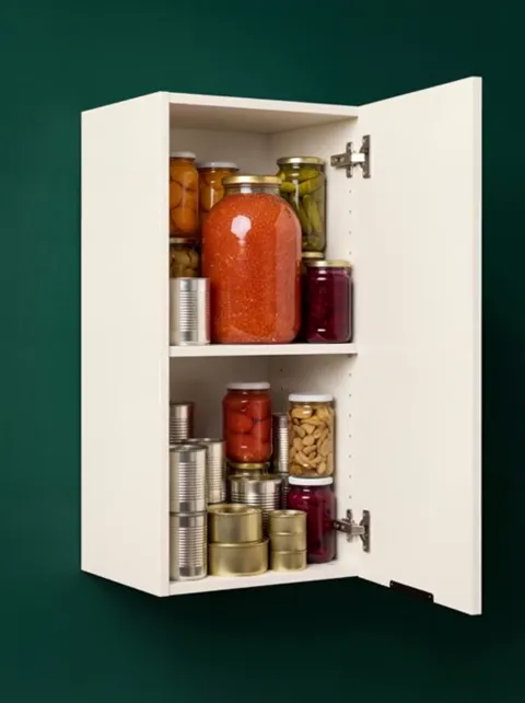 The finale: the cabinet open, the shelves loaded. Eight seconds have shown what actually fits — the only question a wall