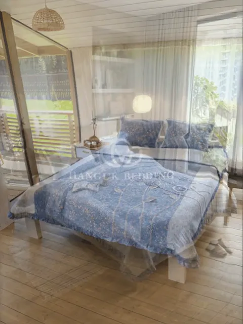 The frame opens on a catalogue shot against white: the coverlet on a bed, a rack of fabric rolls behind. The image is se