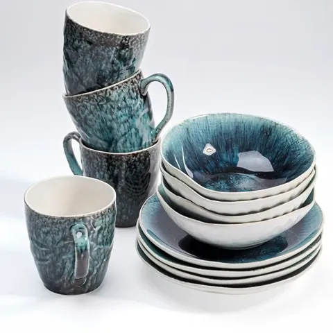 The ground turns grey and the stacks rotate slightly. The glaze pattern emerges: the speckle is uneven, different on eve