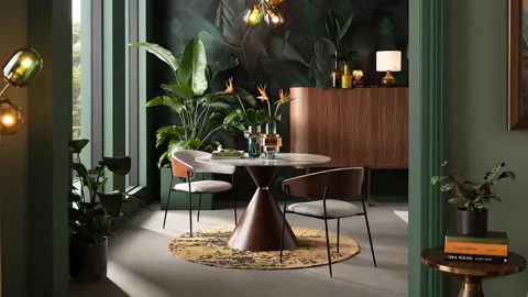 The camera moves forward and the table comes closer. The base is not cylindrical but widens downward into a cone — a for