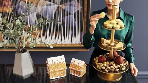 A woman in a green blouse enters and takes a macaron from the top tier. The height of the stand against her hand is visi