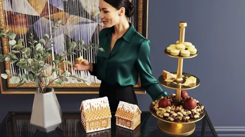 The finale: she reaches for the lower tier. Eight seconds have shown the stand at work — with hands, with food, with rea