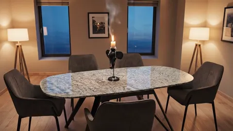 The finale: the table without people, a candle and floor lamps burning. Eight seconds have shown one table across three 