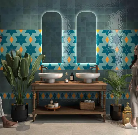 A bathroom with two backlit arched mirrors. The wall carries a large blue and turquoise star pattern with orange inserts