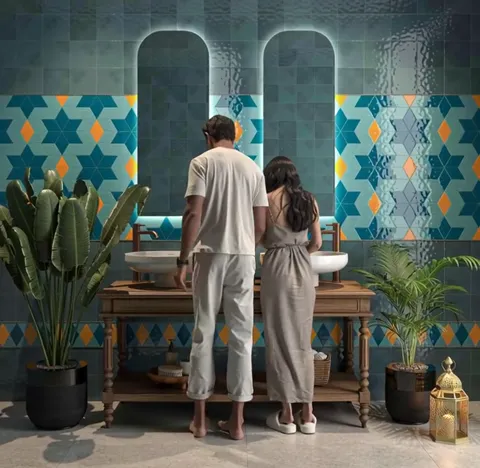 The finale: the couple at the mirrors, light from the arches falling across the wall. The frame shows the collection in 