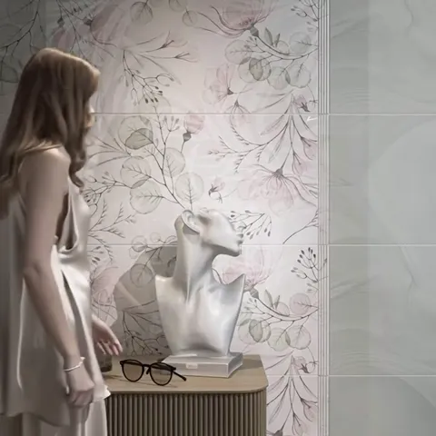 A wall in a watercolour floral: branches, leaves and pale pink buds on a light ground. A console and a white sculptural 