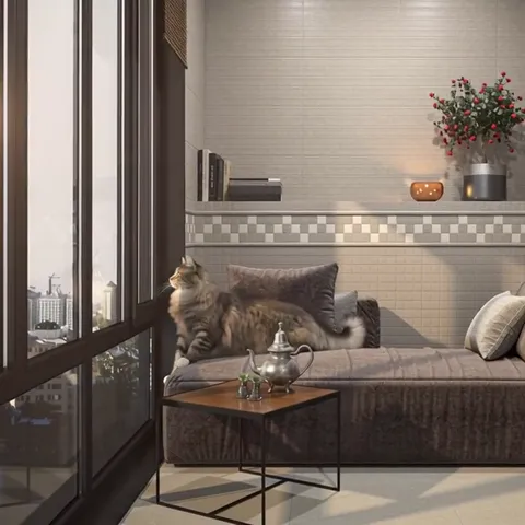 The finale: the cat stands on the daybed, tail to camera, the border reading whole behind it. The frame shows the materi