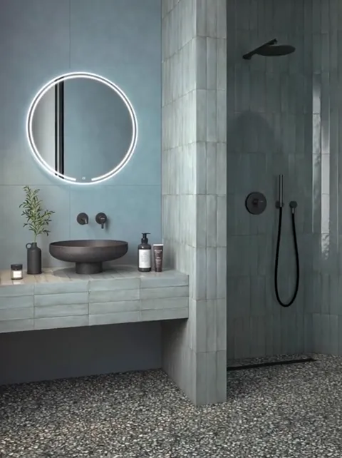 The camera shifts and the wall behind the mirror moves to a different tone. The same material reads blue on the left and