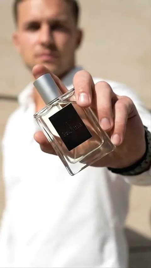 The bottle closer, the label legible. The glass is faceted at the sides and the cap is matte metal.