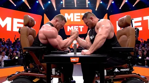 The pull-back continues and reveals what the first frames did not: both are sitting in active wheelchairs. The meaning o