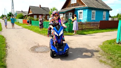 The scooter steers round a puddle. Ground clearance is enough not to catch — a parameter given in centimetres that means