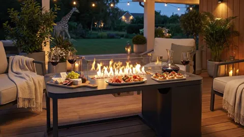The flame rises. The fire comes from a burner set flush with the top — working surface for tableware remains on both sid