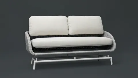 The ground turns grey and the sofa rotates. The weave of the side emerges: horizontal courses wrapping the seat on three