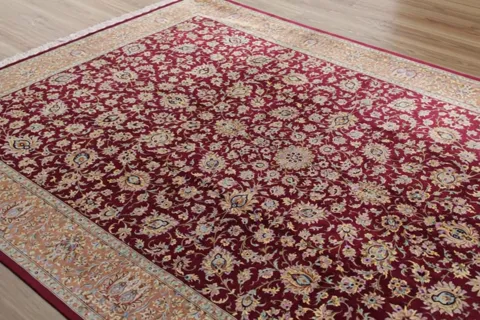 The camera travels along the rug and the viewing angle changes. The pile answers the shift: the burgundy goes darker, th
