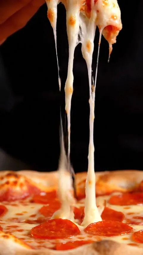 The finale: the slice almost out of frame, the strings still holding. Eight seconds have shown the very reason pizza get