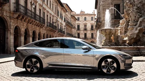 The finale: the car at the centre of the square, pigeons rising. Eight seconds have shown the bodywork in reflections, w