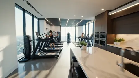 The passage opens into the building's gym: treadmills, machines, people training. This is not the flat but shared amenit