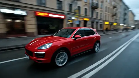 The car at three-quarters, the flank close. The shoulder line of the body reads, and the reflection of the street runs a