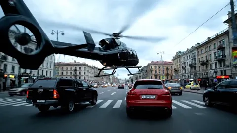 A helicopter enters above the avenue, the cars beneath. Three levels of action at once: ground, air and the depth of the
