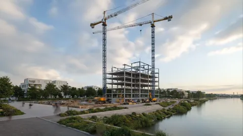 On the same spot, cranes and a steel frame have risen. Construction runs in compressed time — the plot and the angle nev