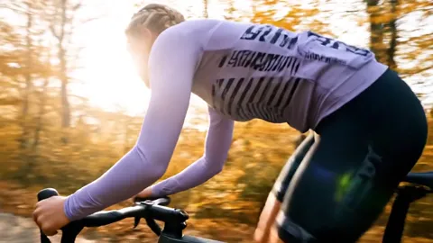From behind, in the riding position: the back horizontal, hands in the drops. The frame geometry under load reads — the 