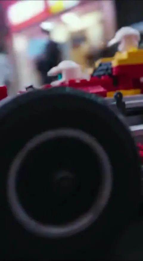 Macro on a wheel: the plastic texture and the joints between parts are visible. The toy is shot like a real racing car —