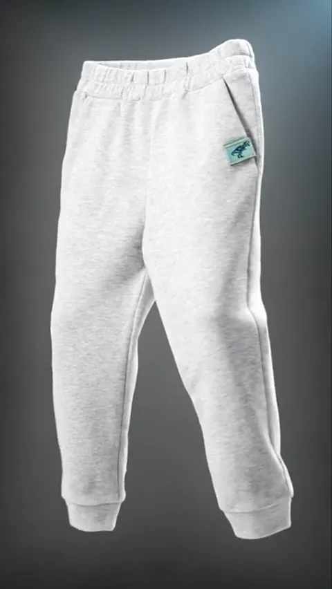 A dark ground, the trousers hanging in mid-air: pale marl loopback, a broad waistband, a label at the pocket. Backlight 