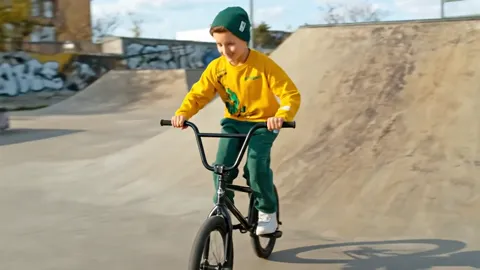 The finale: the boy at the lip of the ramp, smiling at the camera. Eight seconds have shown children's clothing in extre